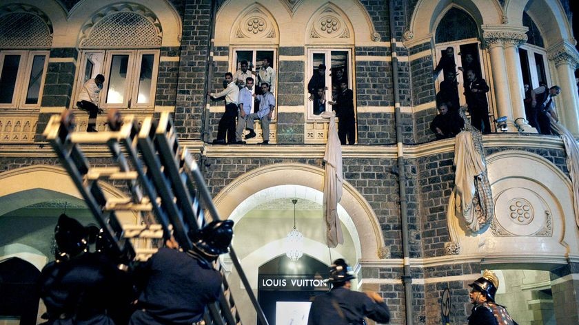 Employees and guests of the Taj Mahal Palace hotel are rescued by firefighters