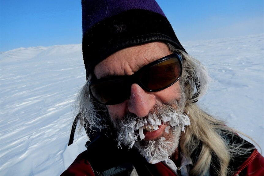 A man with a frozen beard in the Arctic.