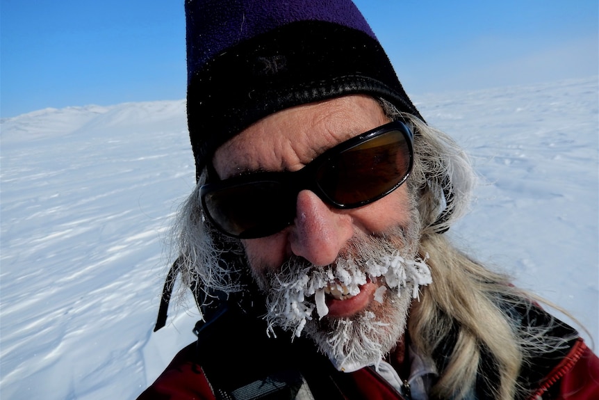 A man with a frozen beard in the Arctic.