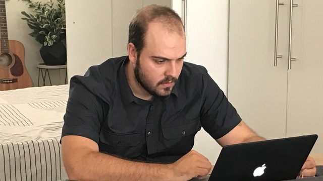 Thiago Deoti working on a laptop