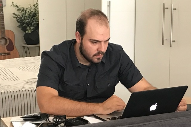 Thiago Deoti working on a laptop