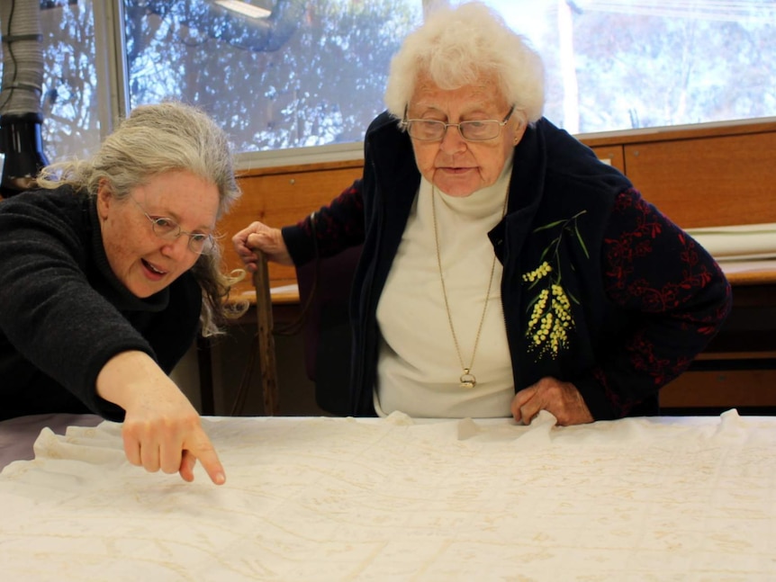 National Museum of Australia curator Dr Martha Sears with Doreen Godtschalk, viewing the 1894 autograph quilt at the museum's storage facility.