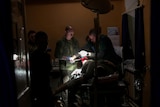 A group of doctors operating on a soldier