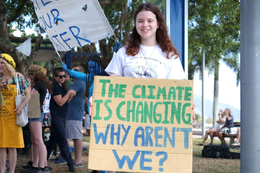 A teenager holding a placard calling for action on climate change