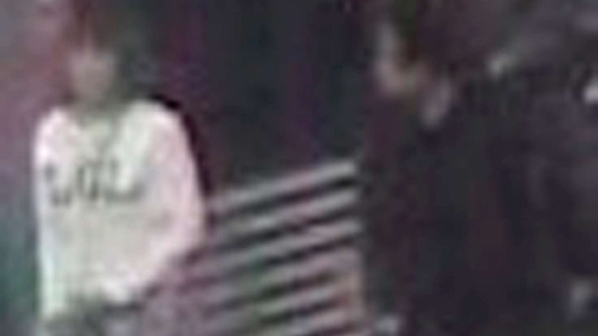 A grainy CCTV still shows a woman at Kuala Lumpur airport wearing a white shirt with 'LOL' on the front.