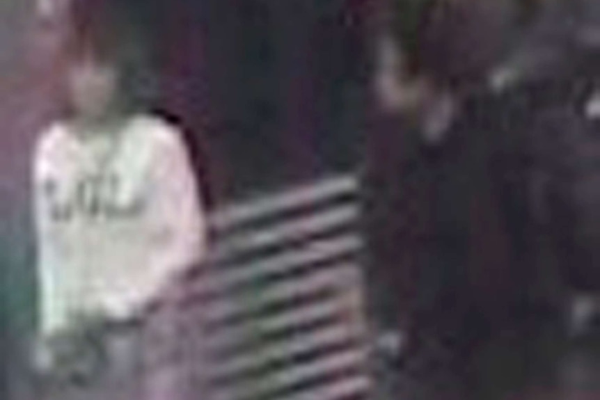 A grainy CCTV still shows a woman at Kuala Lumpur airport wearing a white shirt with 'LOL' on the front.