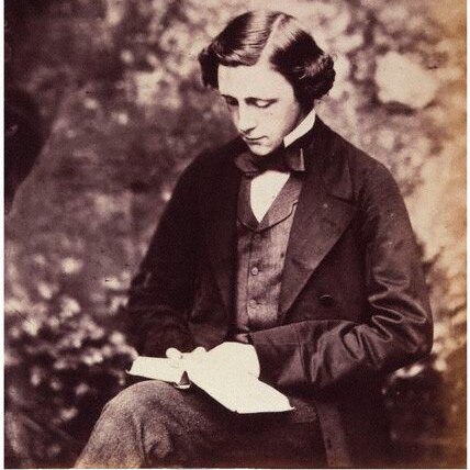 Lewis Carroll reads a book in a photo dated 1857.