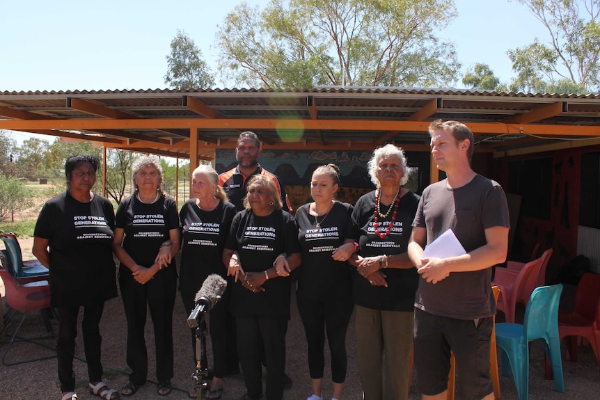 A group of women from Grandmothers Against Removals speak in Alice Springs.