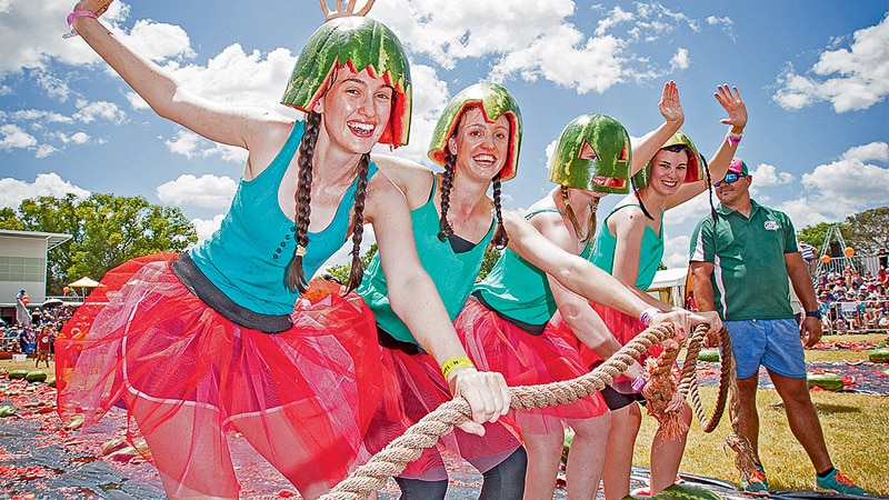 The four girl watermelon ski team line line up in watermelon coloured outfits, ready to start.