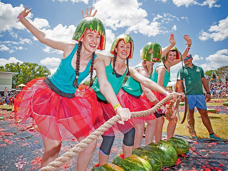 The four girl watermelon ski team line line up in watermelon coloured outfits, ready to start.