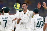 Mitchell Starc is congratulated by his teammates after taking a wicket in Perth