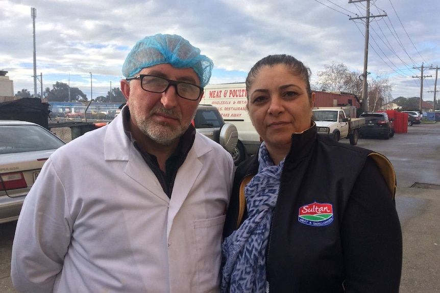 Muhsine Eskici (right) stands near her meat supply business. She says air quality in Dallas is bad after a nearby fire.