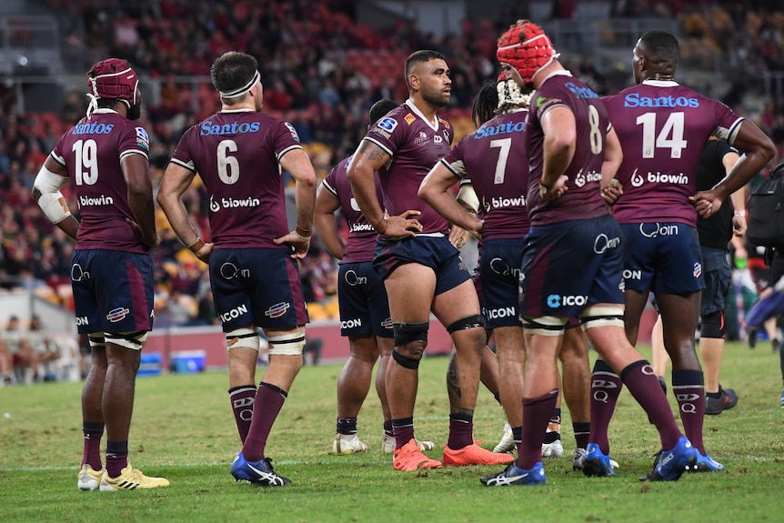 A group of Queensland Reds players regroup after conceding a try against the Crusaders.
