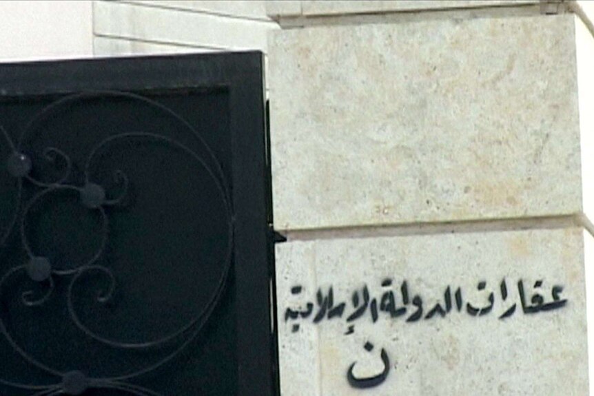 Arabic graffiti on a church in Mosul reads: "Real estate property of the Islamic State."