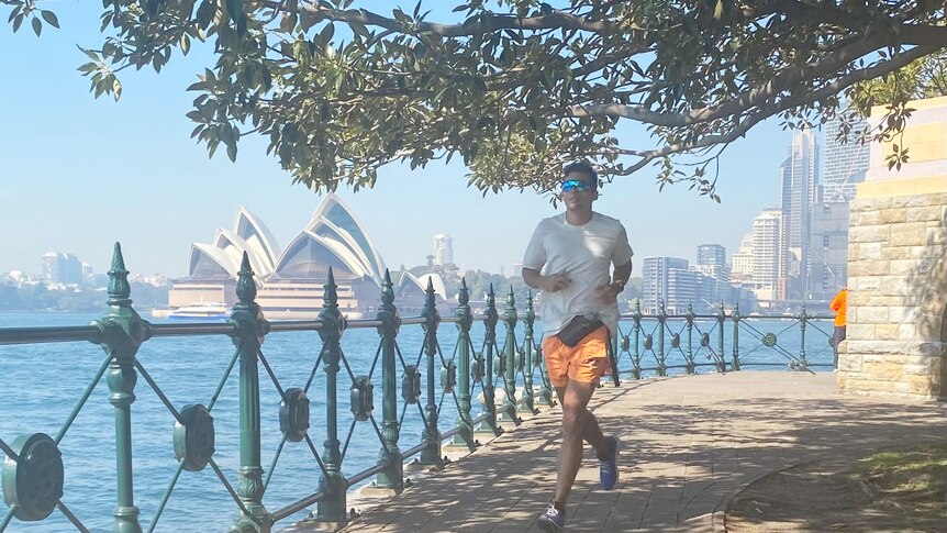 A man jogs around Sydney Harbour