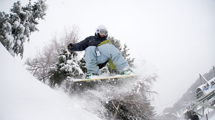 A snowboarder enjoys the heavy snow falls at Falls Creek. August 2010.