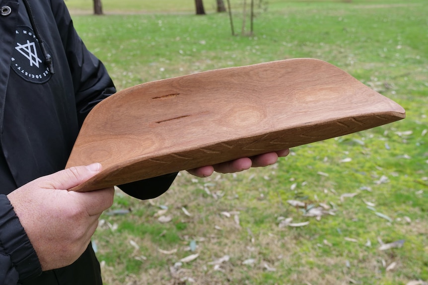 A smooth, long wooden vessel.