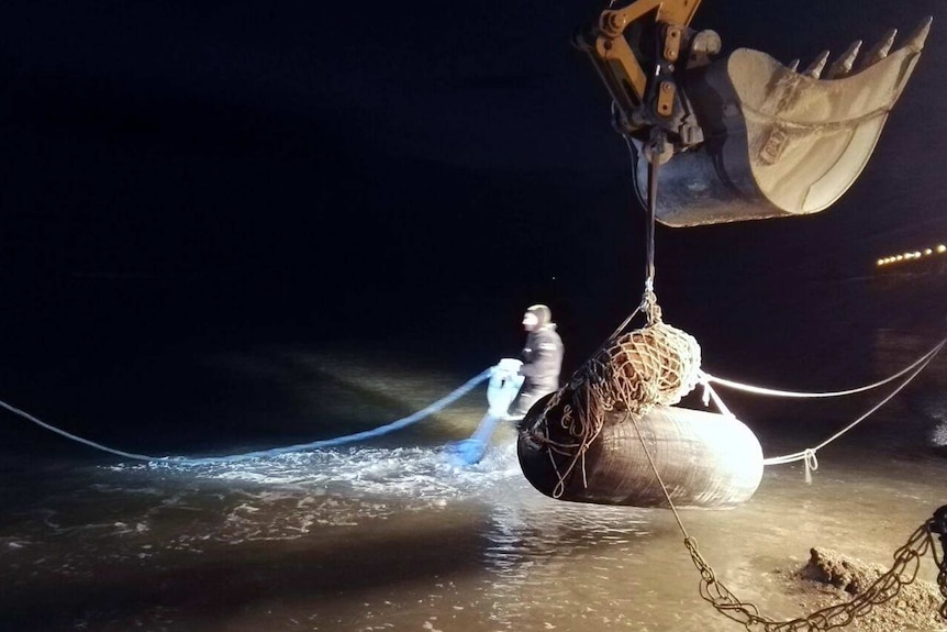 The World War II British bomb on a crane by the sea.