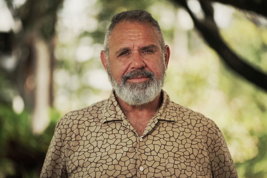 Professor James Ward, wearing a colourful open-necked shirt, looks into the camera.