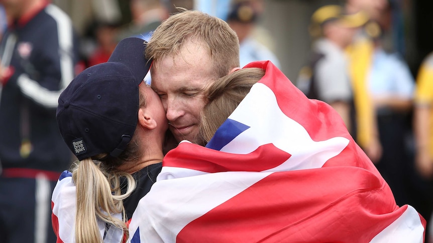 Great Britain's Steve Sebburn celebrates with family after winning road race time trial