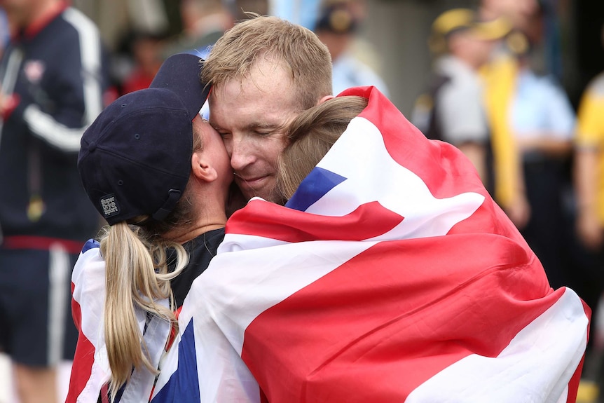 Great Britain's Steve Sebburn celebrates with family after winning road race time trial