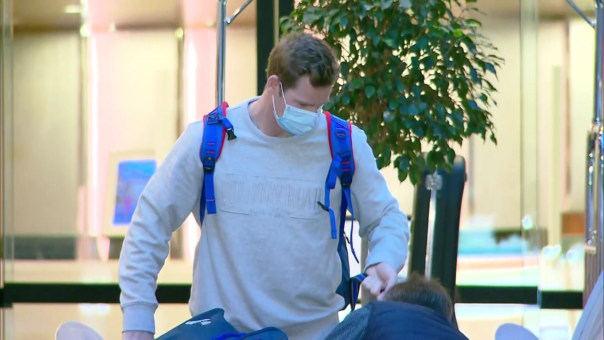 Steve Smith wearing a mask carrying bags