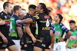 Two rugby league players embrace after a try 