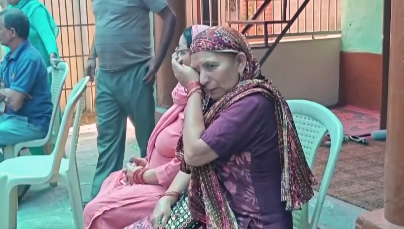 Family of an Indian sailor who died in a US attack in the Strait of Hormuz sititng and crying.
