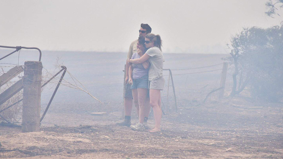 Wasleys residents look at the ruins of their house, which was destroyed in a Bushfire.