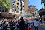 Hundreds of protesters marching through the Brisbane CBD