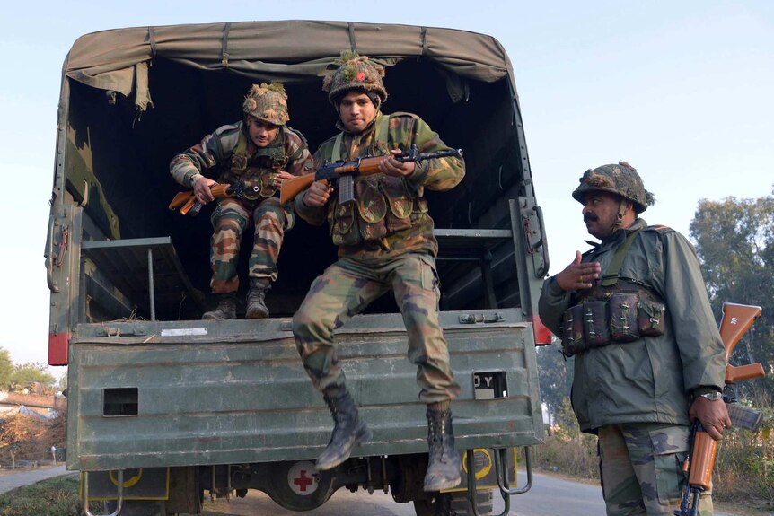 Indian troops disembark truck at Pathankot air base
