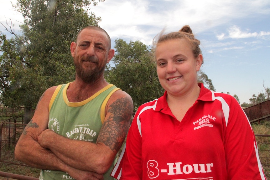 Dwayne and Teagan Barnes  stand outside a central west NSW shearing shed.