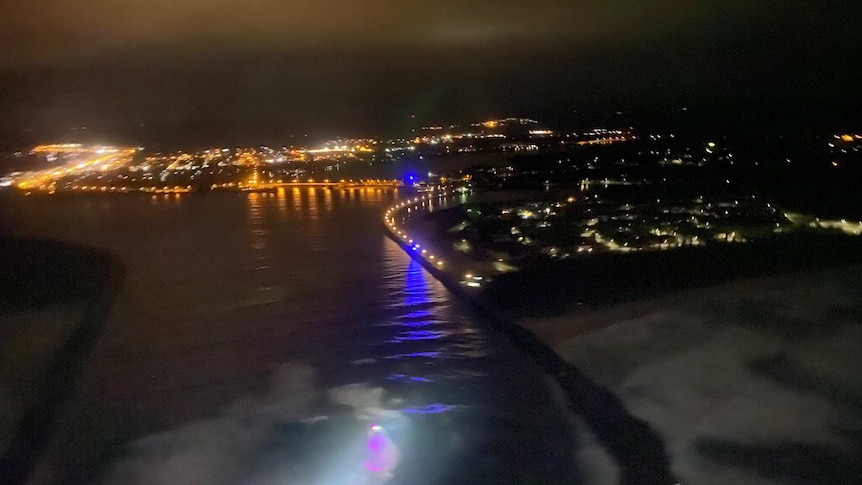 The night lights of Ballina seen from a helicopter hovering over the entrance to the Richmond River.
