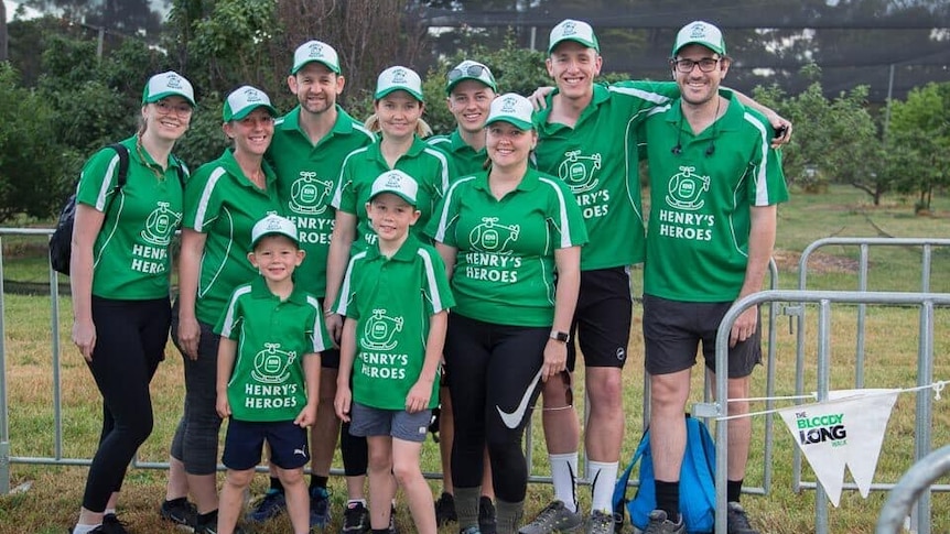 A group of people in matching green shirts.