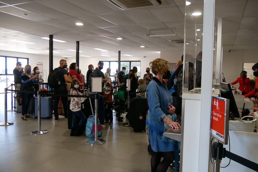people queuing inside an airport 