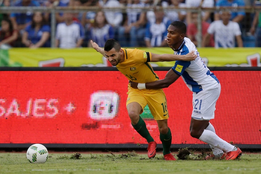 Aziz Behich shields the ball