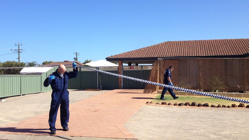 Tape is lifted by a forensic officer outside a Geraldton house where shooting occurred