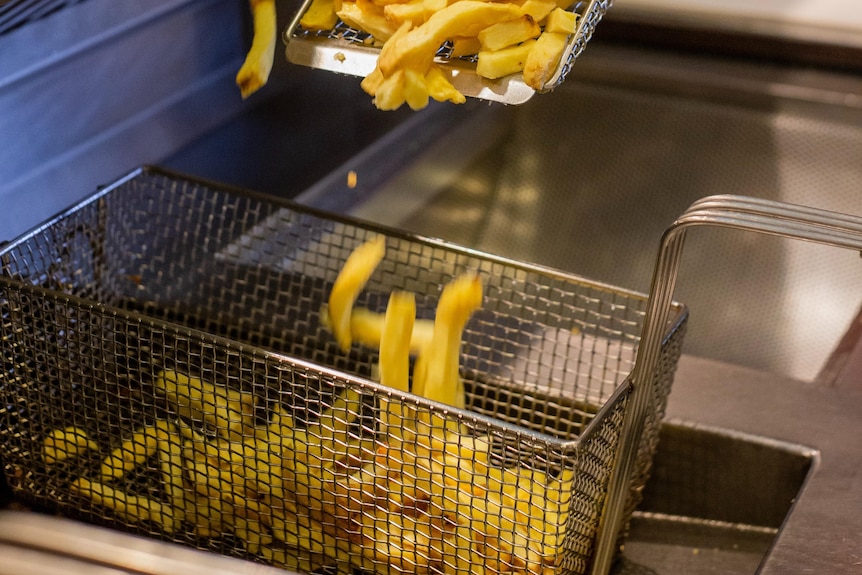 Chips in basket in deep fryer
