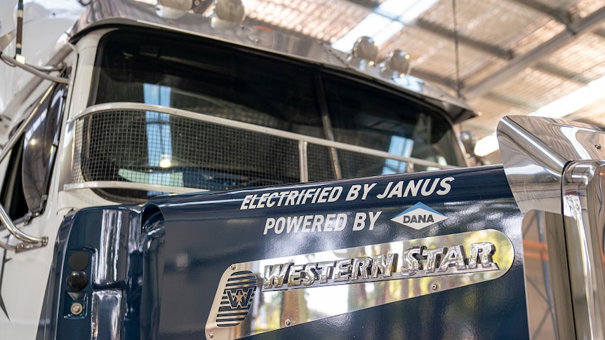 Janus Electric and Western Star signs on the bonnet of a truck