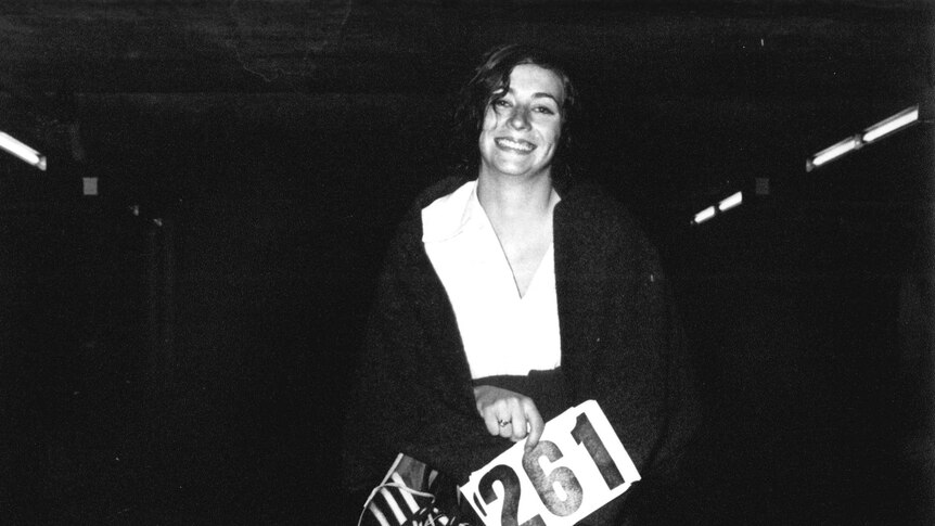 Kathrine Switzer holds her running number and shoes.