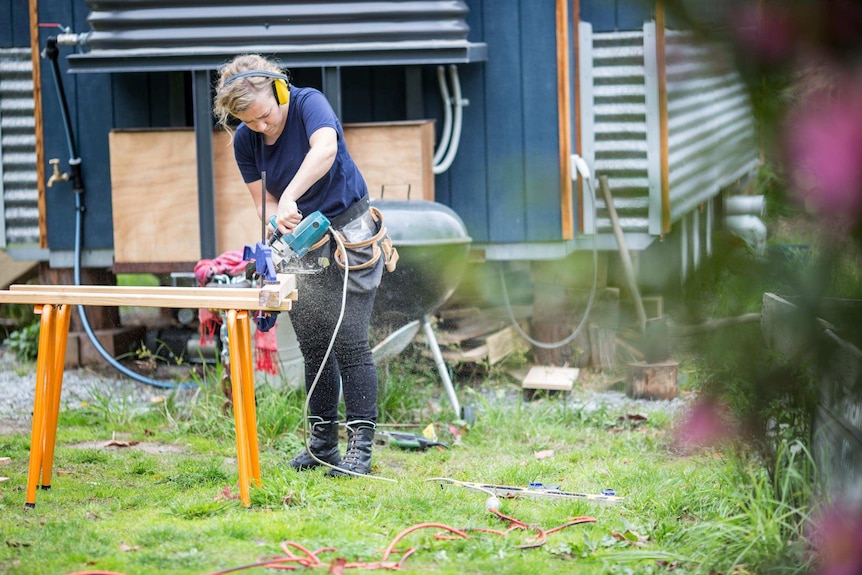 Sarah Smethurst cut wood for her tiny house.