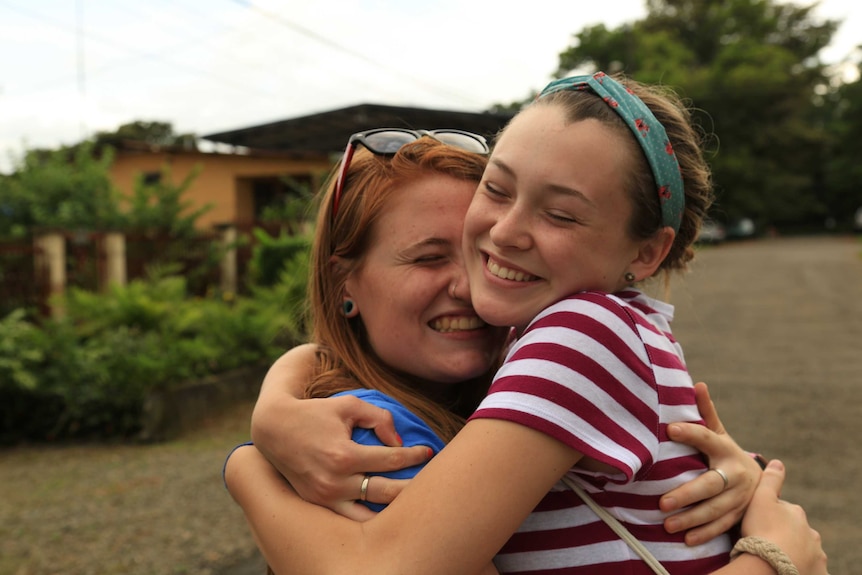 Two women hugging each other