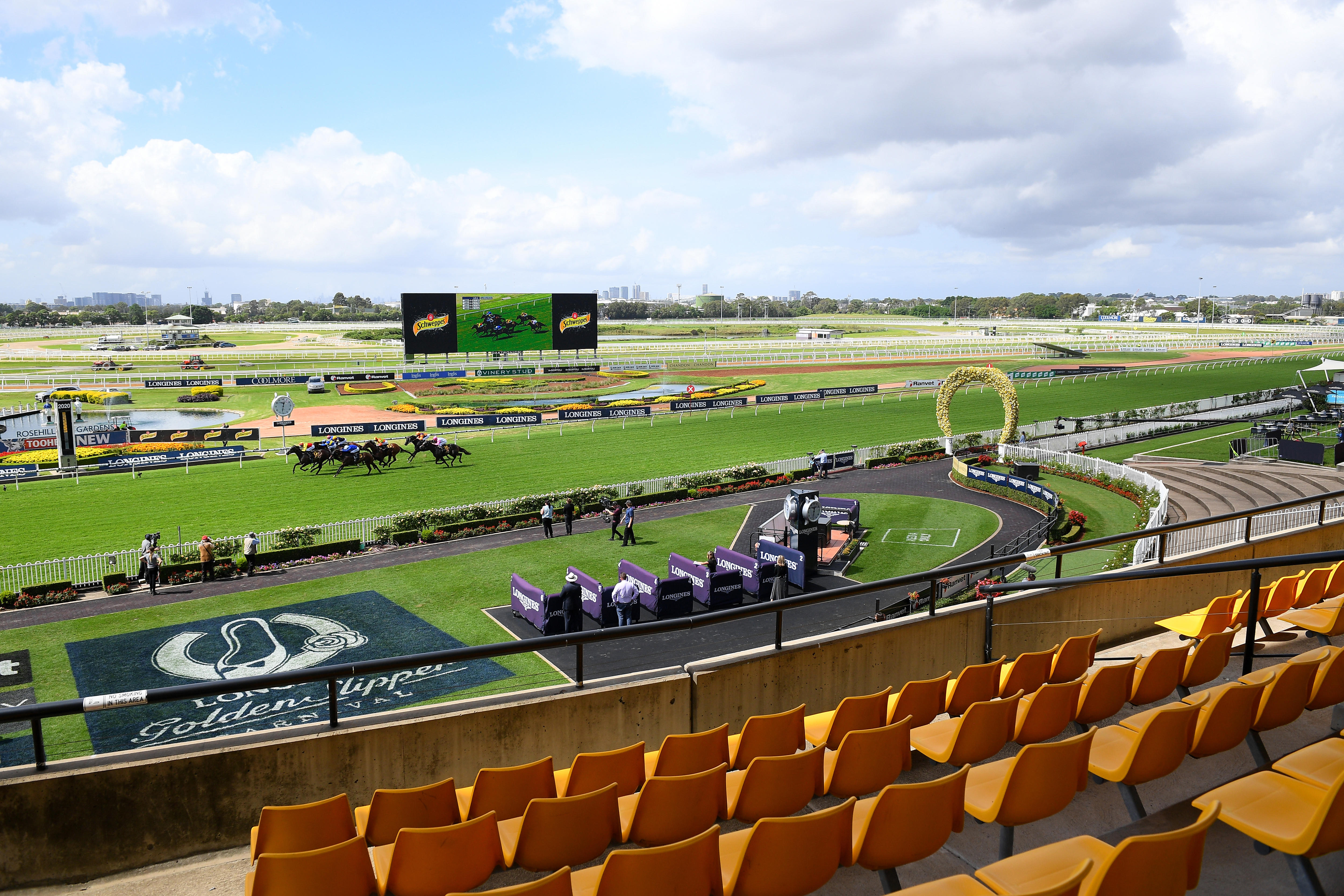 A picture of a horse racing course taken from the grandstand.