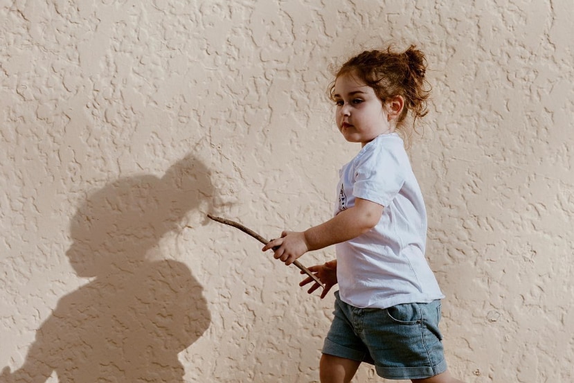 little girl holding stick
