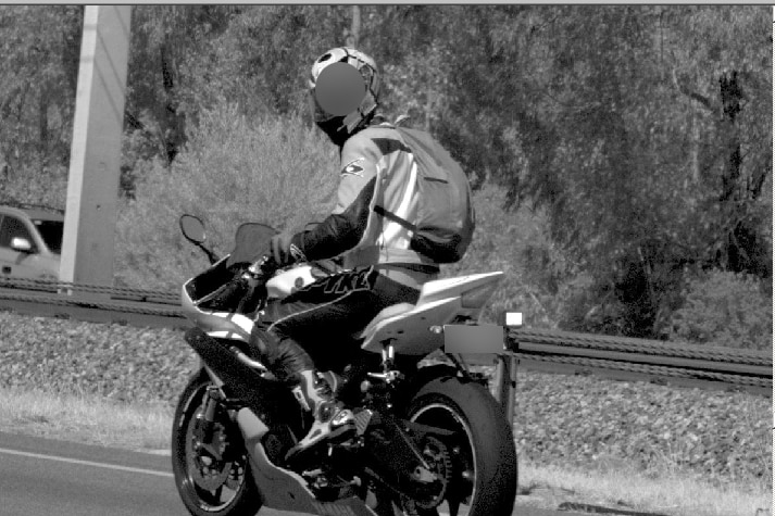 Black and white photo of male driver caught speeding by WA mobile rear-facing speed camera