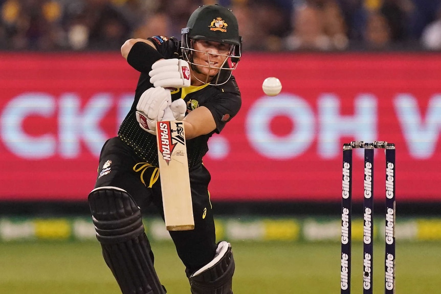 An Australian male batter plays a shot to the off side in a Twenty20 international against Sri Lanka.