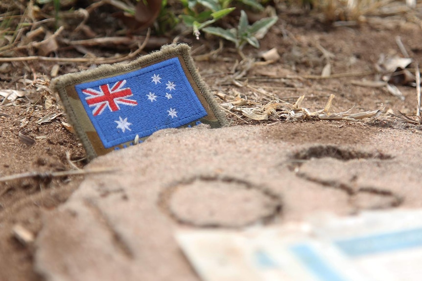 A close-up of a small Australian flag laid on Lt Northover's grave.