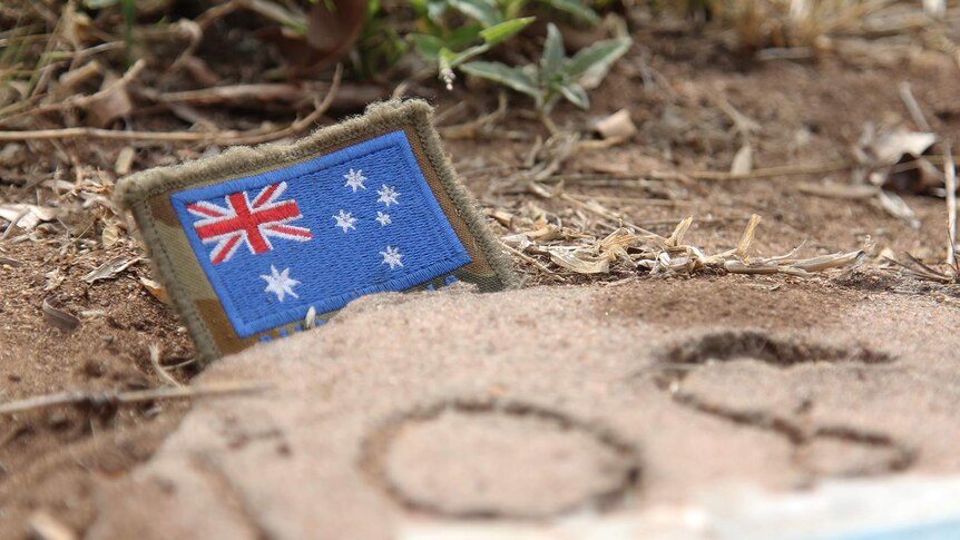 A close-up of a small Australian flag laid on Lt Northover's grave.