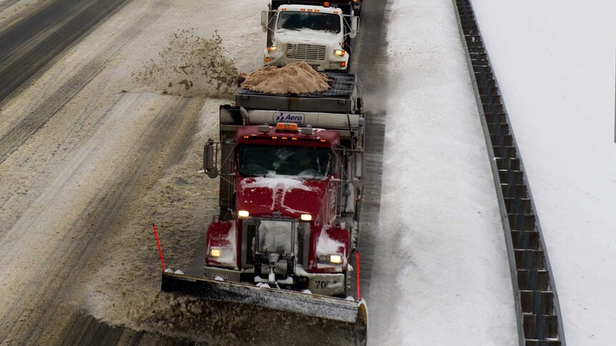 A convoy of snow plow truck