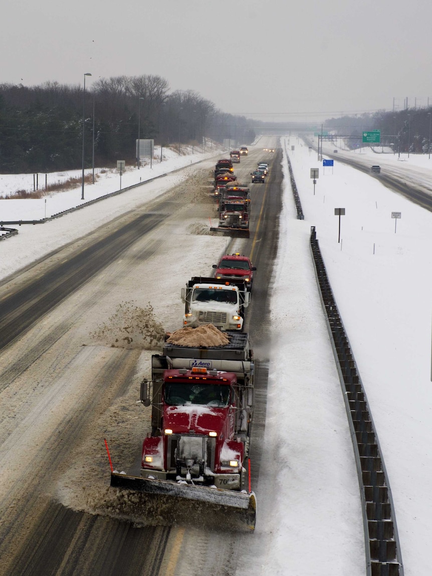 A convoy of snow plow truck